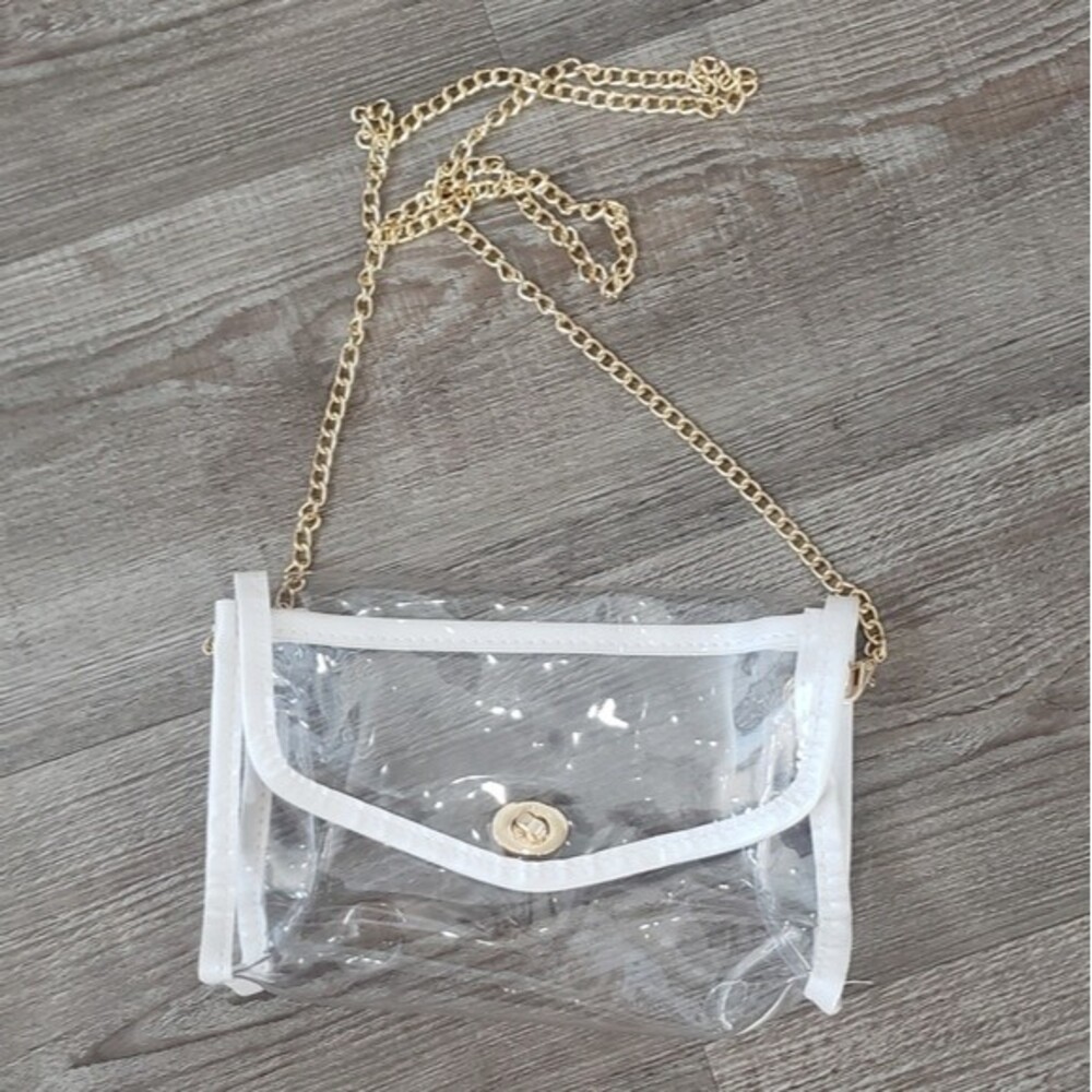 Clear crossbody purse with white trim and gold chain.